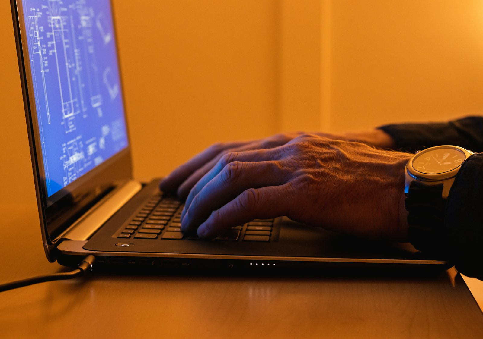 A technician working through a problem on a laptop